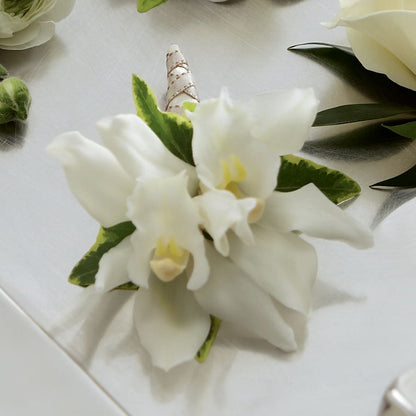 White Mini Cymbidium Boutonniere – GOOSEBERRIES FLOWER SHOP BY BERKOT'S, Twin Lakes WI